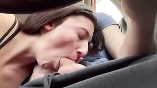 The guy is fucking his girl in the car on a public road trip