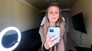 The blonde fucks against the phone, showcasing her big assets