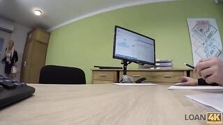 A business woman is trying to get some extra money from a bank employee