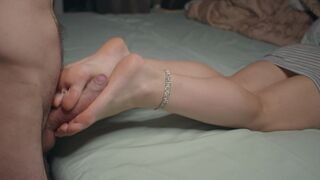 A petite beauty shows off her small feet and gives a footjob