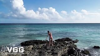A petite girl is playing on a beach, showcasing her solo charm