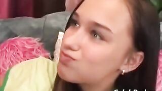 A cute teenage girl is having fun with an adult man on the couch