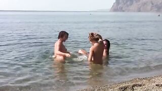 Three nudist girls on the public beach with erporn action