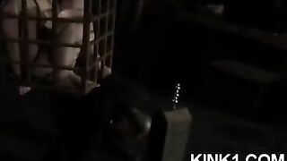 The slave in the cage fulfills all orders of the mistress