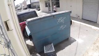 A girl was photographed having sex behind the garbage tank