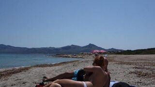 A blowjob in public on the sandy beach is an exciting act