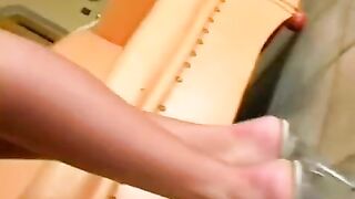 Brunette masturbating her pussy on a leather chair with a powerful vibrator