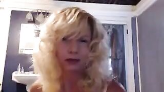A nice woman aged herself pleases in the bathroom with a toy