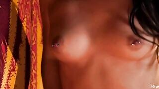 A girl with a clitoral piercing plays with her wet pussy