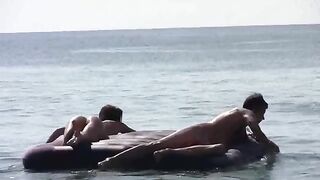 A young girl sunbathes naked on the sandy coast