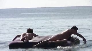 A young girl sunbathes naked on the sandy coast
