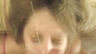 A cumshot on the face of a blonde after a blowjob session