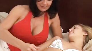A girl has a lesbian sex with her big-breasted girlfriend using a strap-on