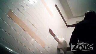 The camera is secretly placed in the woman's toilet, and she is peeing