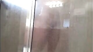 The guy washes in the shower, but he does not know that he is being filmed