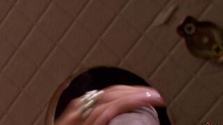 A beauty pulled a dick through the hole in the toilet and started sucking