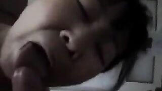 The Chinese woman practices her blowjob skills on her man in a steamy bedroom session