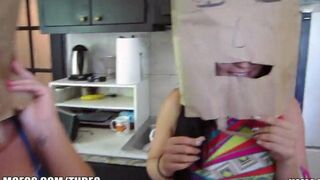 The girls wear on their heads bags and run on the street