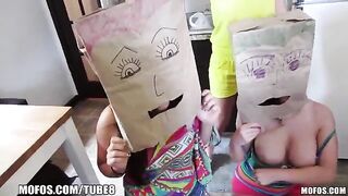 The girls wear on their heads bags and run on the street