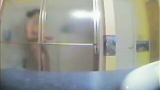 A girl has no idea that someone is watching her in the shower