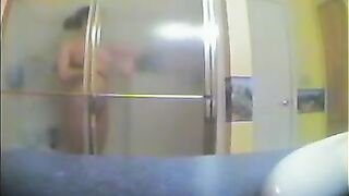 A girl has no idea that someone is watching her in the shower
