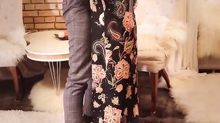 The sexy redhead in a long black dress and stockings is fucking wildly
