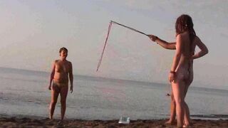 A naked girl is having fun on the beach
