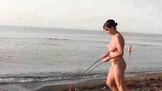 A naked girl is having fun on the beach