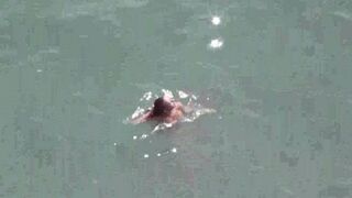 A pair of lovers have fun directly in the sea without any clothes