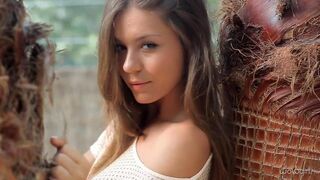 A beautiful Russian girl named Katerina is removing her clothes