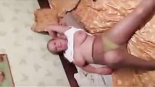 A pregnant woman exposes her breasts to the photographer