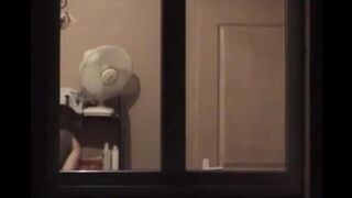 The guy looks at himself in the mirror, admiring his naked body