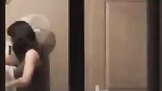 The guy looks at himself in the mirror, admiring his naked body