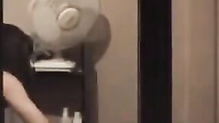 The guy looks at himself in the mirror, admiring his naked body