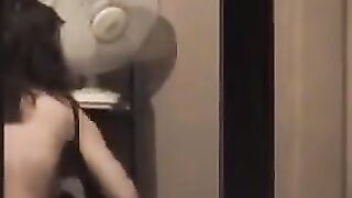 The guy looks at himself in the mirror, admiring his naked body