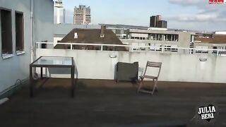 A hot brunette with big tits has sex on the roof