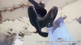 A hot naked girl is having fun in the pool with a videographer