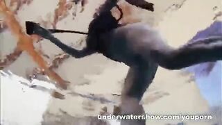 A hot naked girl is having fun in the pool with a videographer