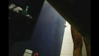 A girl washes herself in the shower, not suspecting a hidden camera