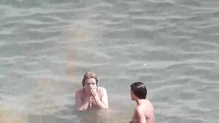 Two hot girls are taking a bath in the sea naked