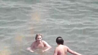 Two hot girls are taking a bath in the sea naked