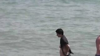 Two hot girls are taking a bath in the sea naked