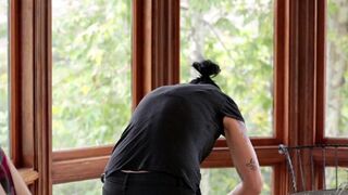 A cute Vietnamese girl fucked in the kitchen by a horny lesbian with a strapon