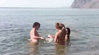 A group of free-spirited people enjoy fun and relaxation on the naked beach