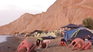 A hot naked chick is playing volleyball on the nude beach