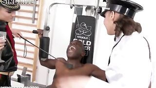 Two girls have fun with a negro in full latex