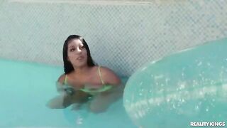 A hot girl has a swimming lesson in the pool