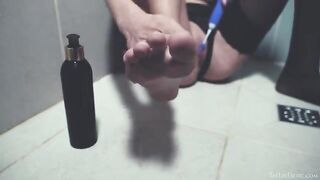 Girl washes in the shower and caresses her clitoris with a toy