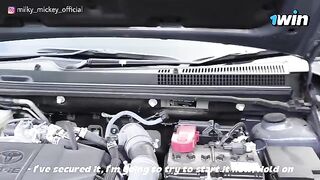 A beautiful girl was fixed by a handsome guy when her car broke down