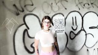 The girl is celebrating having a new home in an unfinished building
